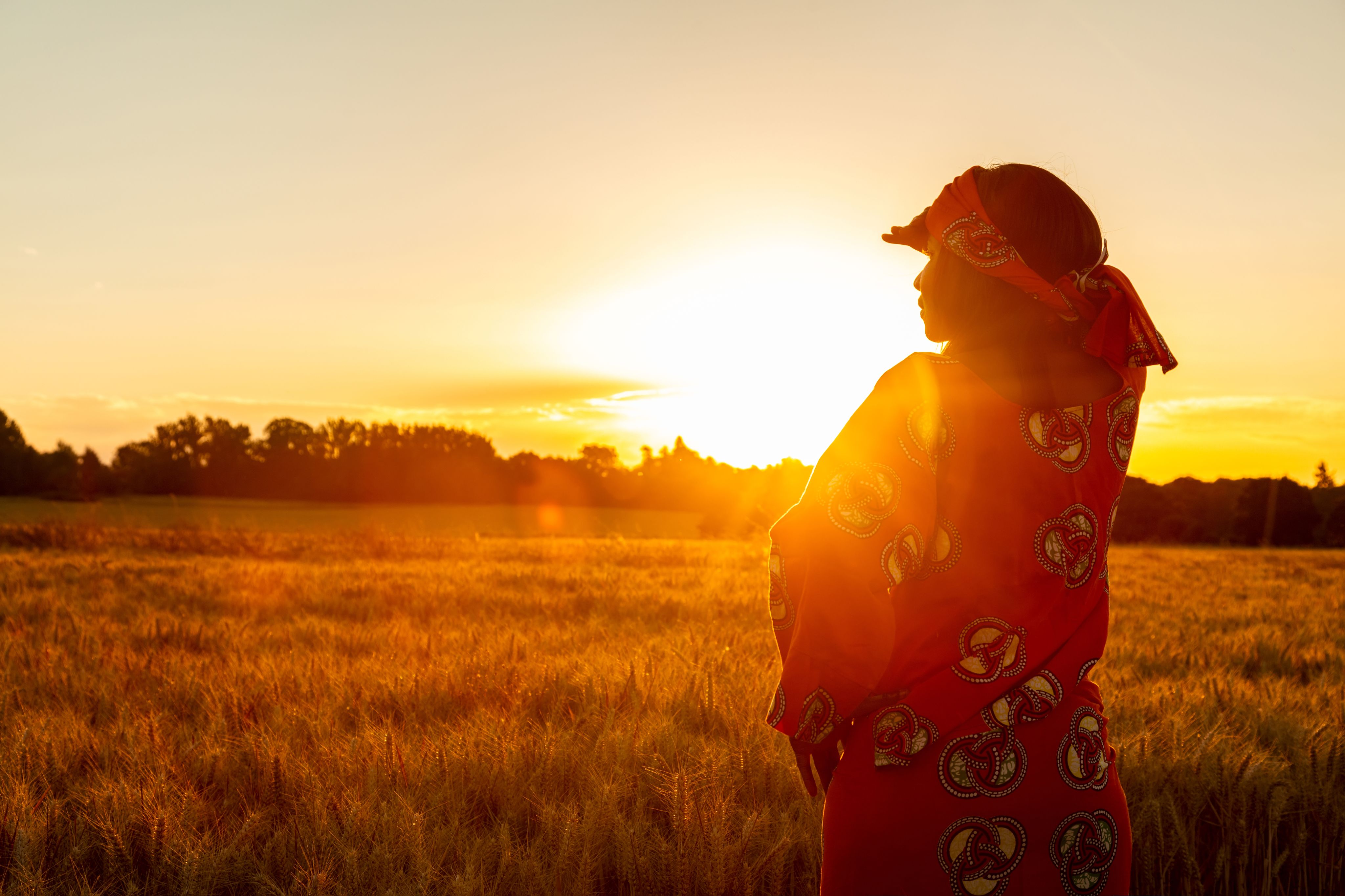African woman looking across field