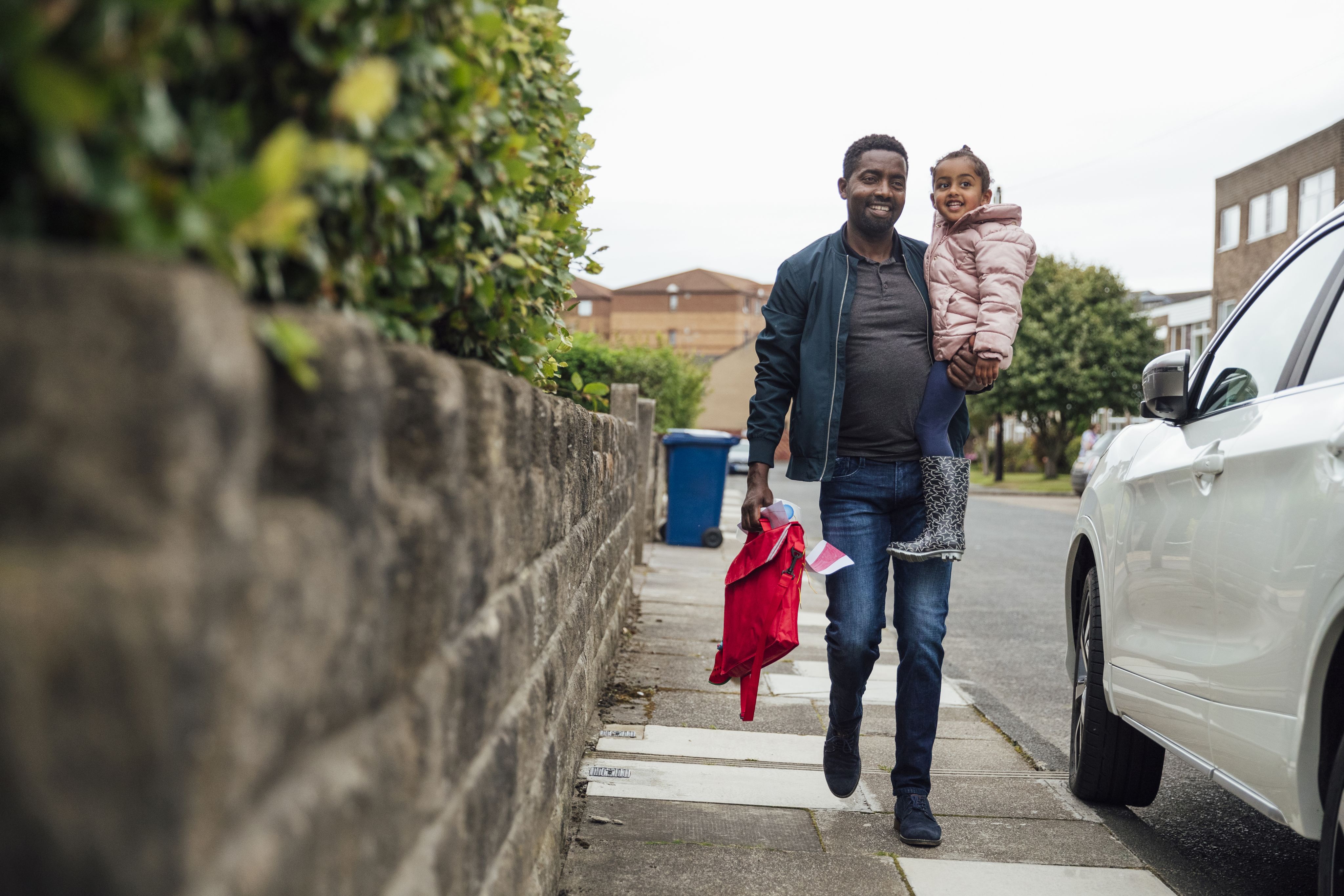 Man walking daughter home from nursery