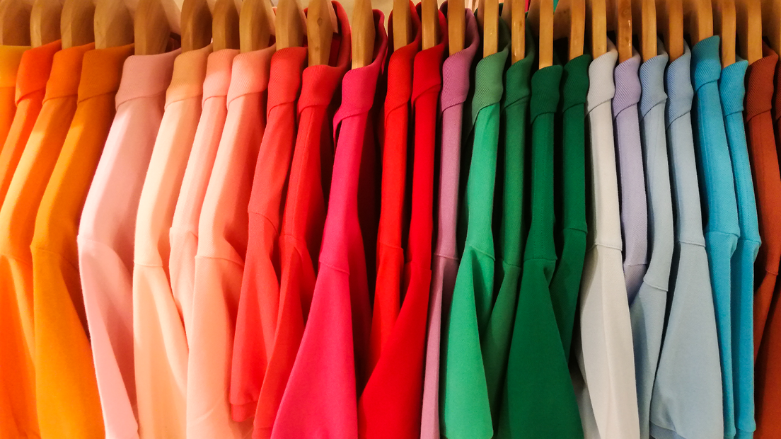 A row of colourful dyed shirts.