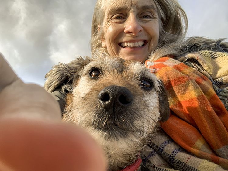 A selfie shot of a woman with her patterdale terrier.