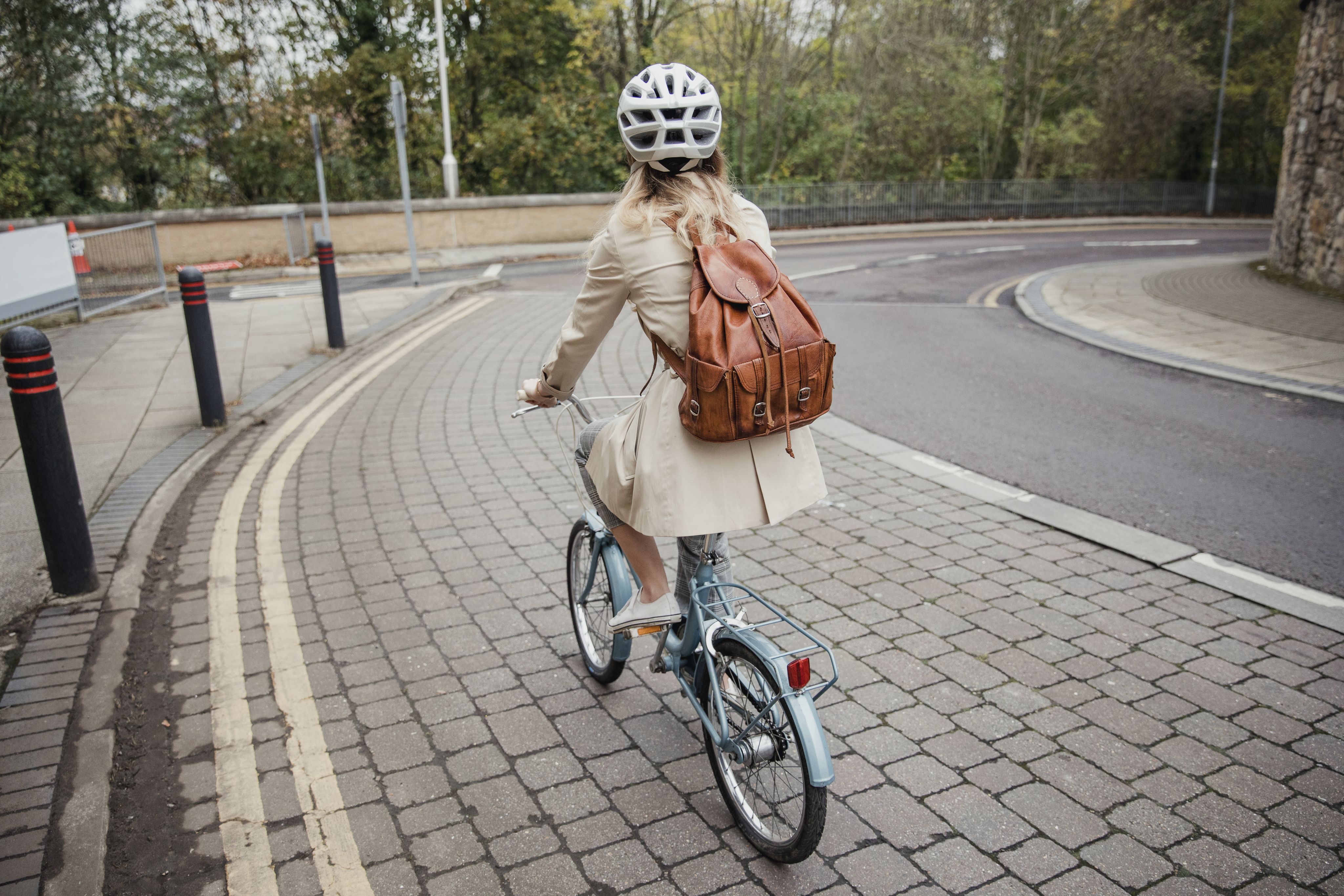 A woman cycling through a town.