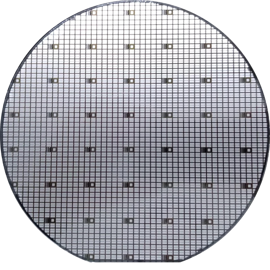 A finished semiconductor: a silver circle with black grid lines running through it horizontally and vertically. At regular intervals are larger black squares.