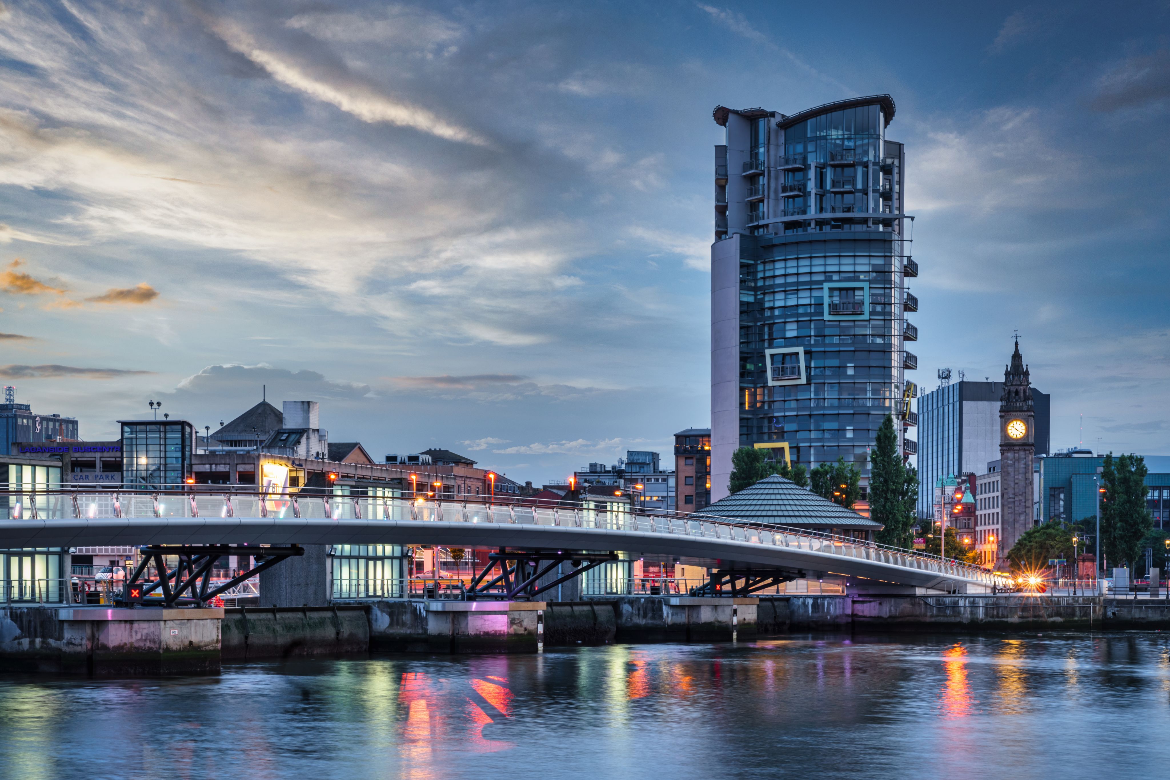 Belfast city sunset with colourful twilight over Lagan Weir pedestrian and cycle burdge spanning over the Lagan river