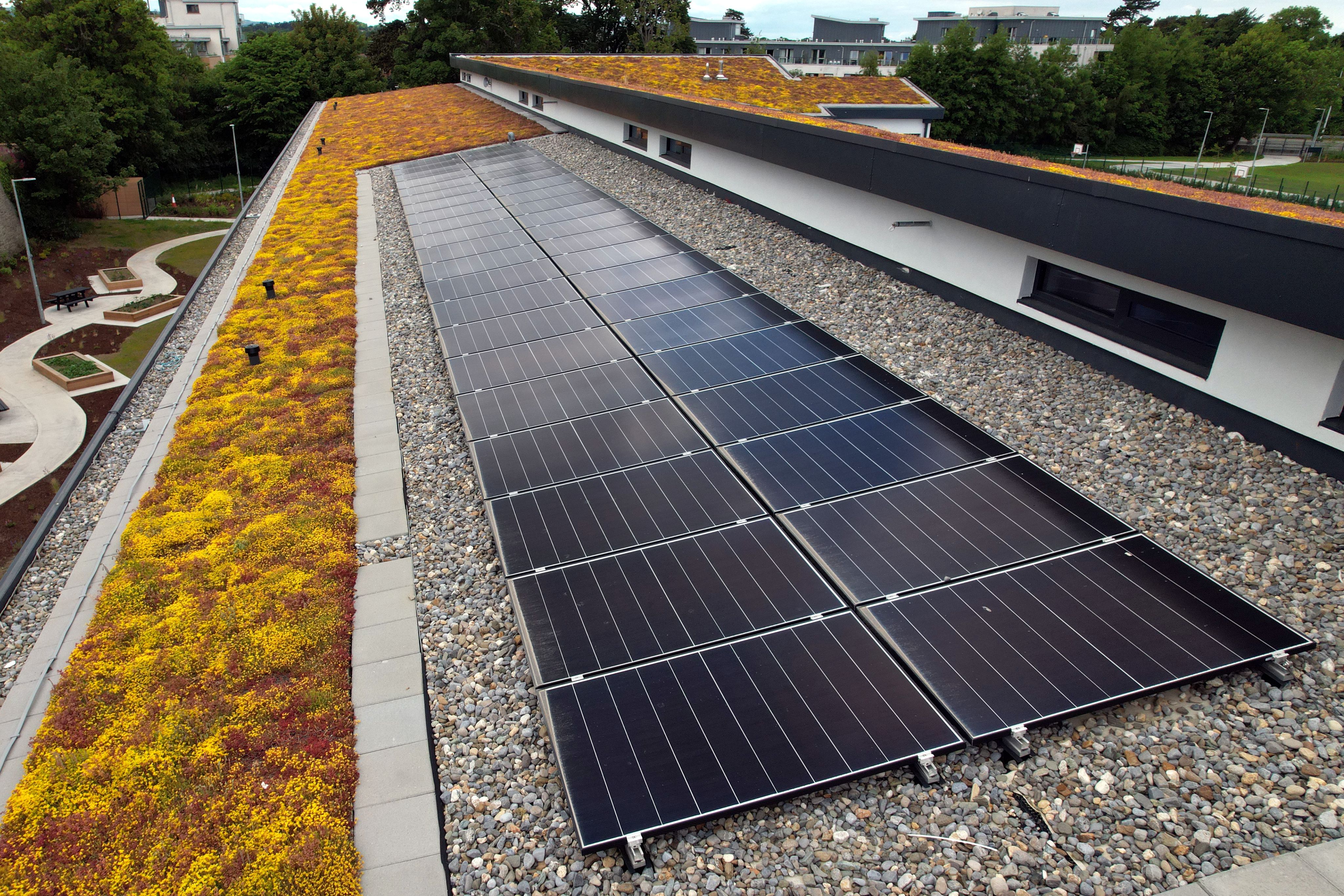 An energy efficient building in Northern Ireland with solar panels and a green sod roof