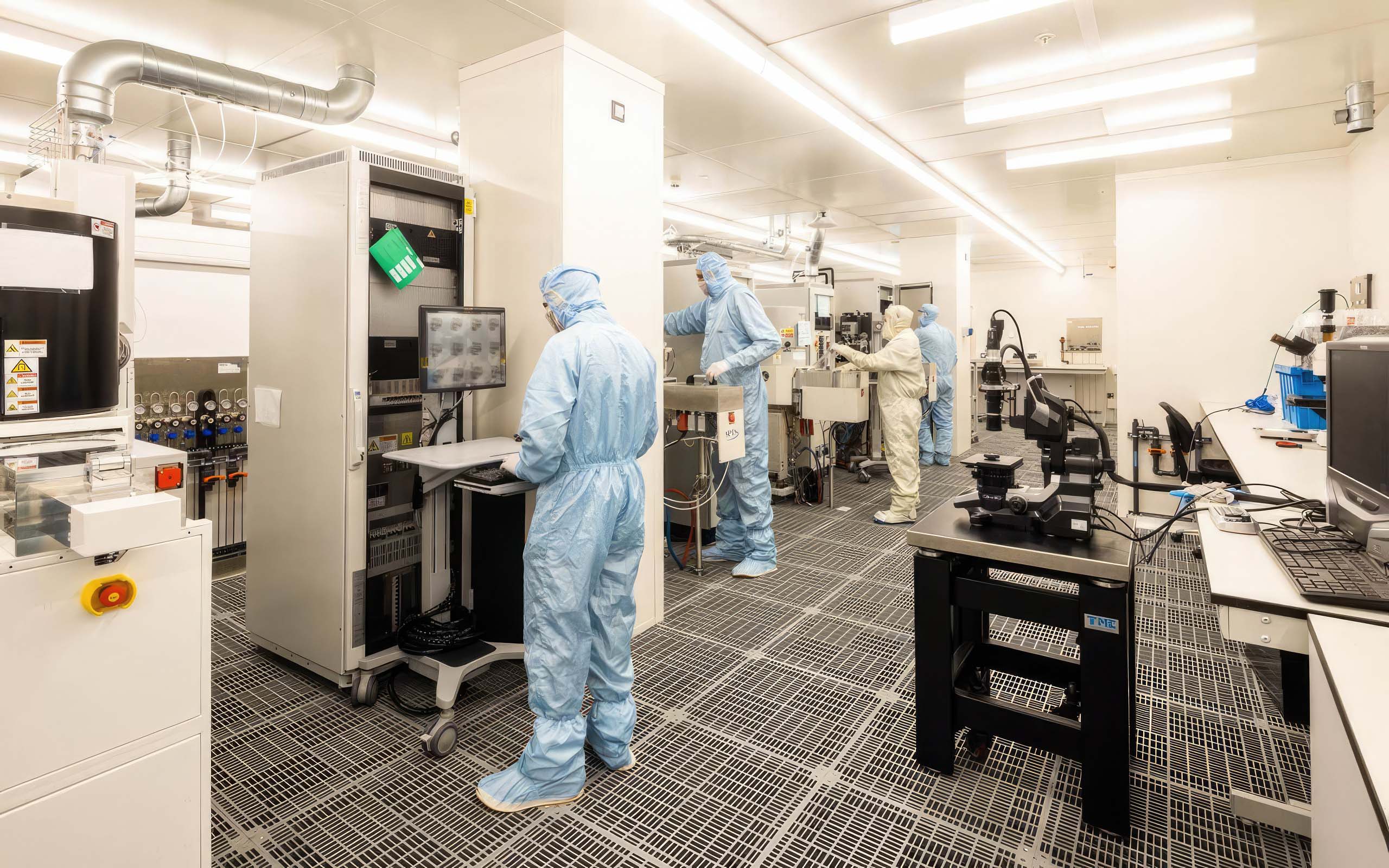 Laboratory workers in protective clothing working in a high tech laboratory enviornment
