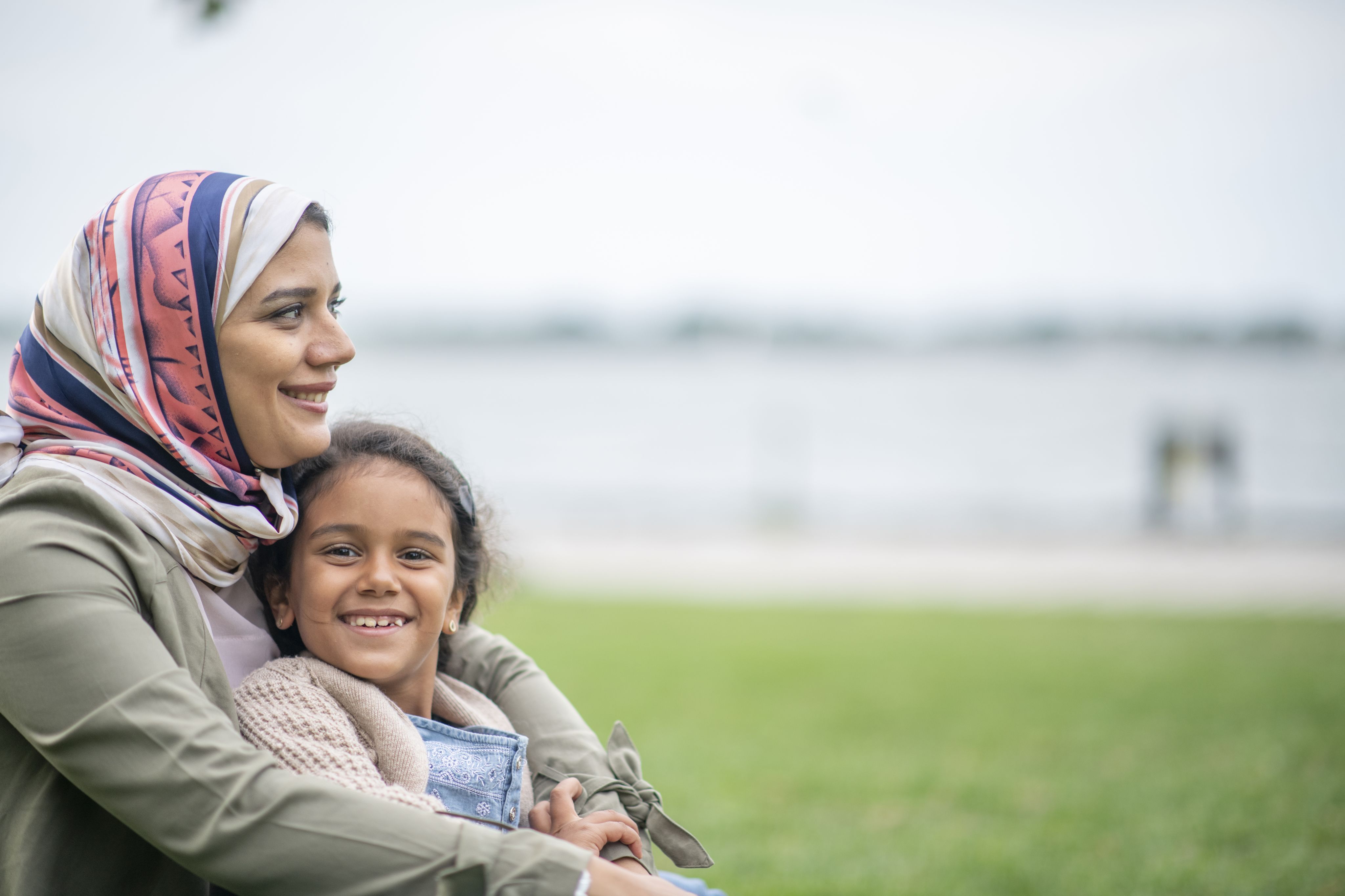 A migrant mother and daughter smiling