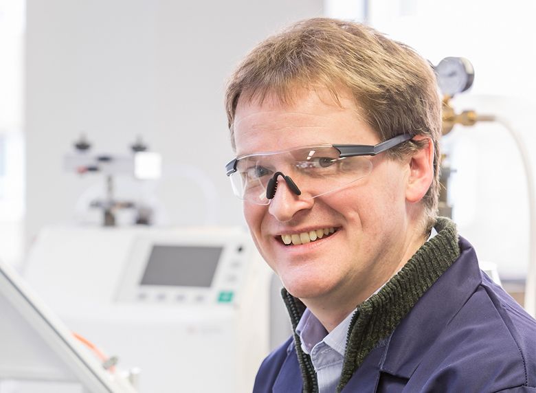 Dr Richard Dawson, technical director, LiNa Energy inside his laboratory. He is wearing safety glasses.