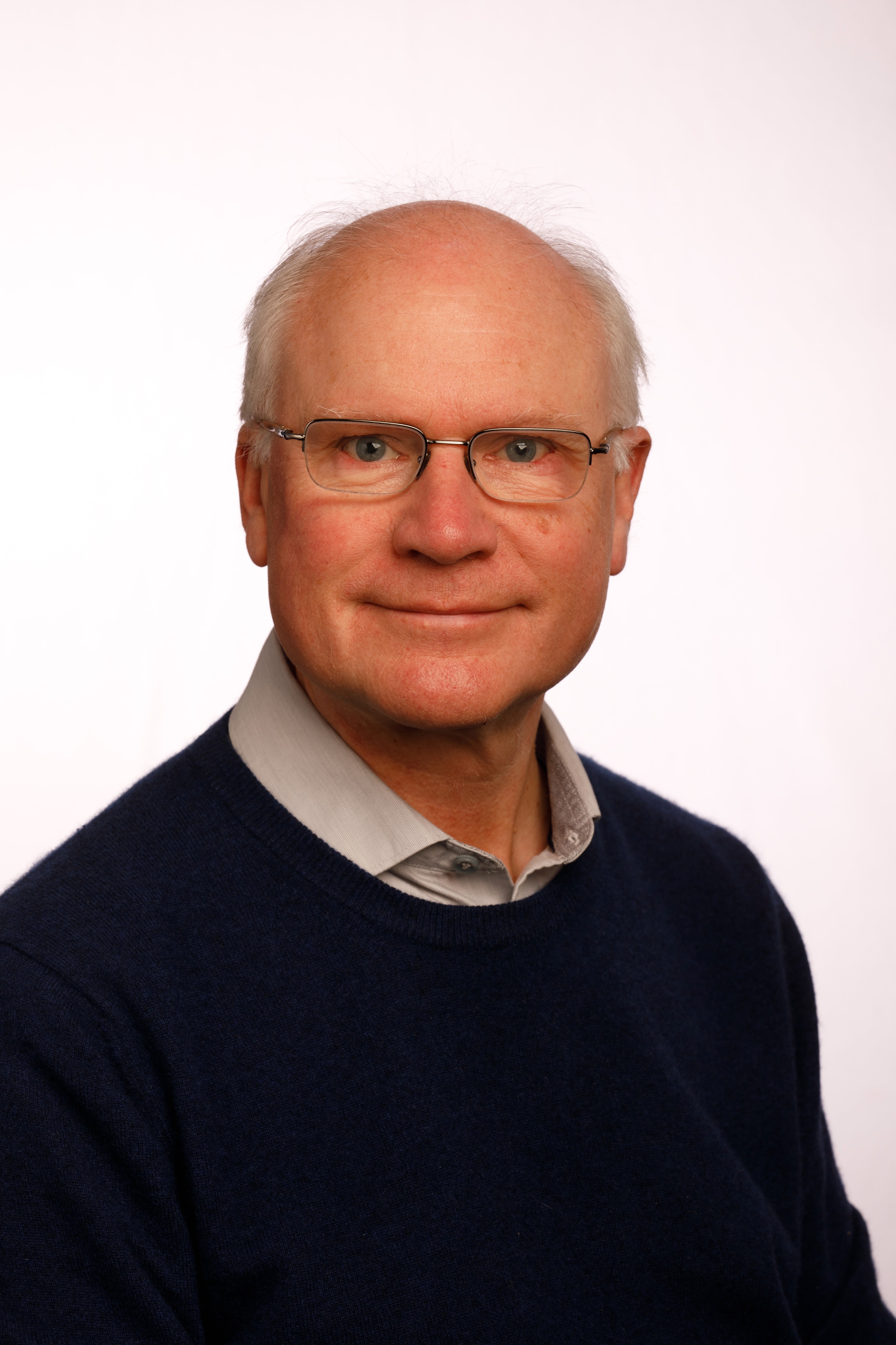 A portrait photograph of Professor Sir Mike Ferguson 