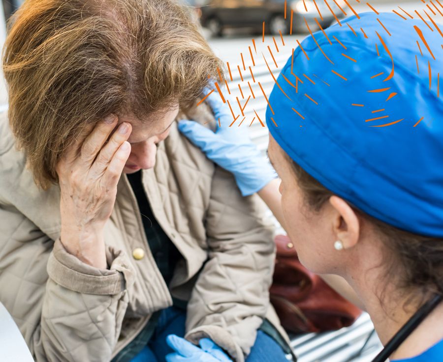 Female doctor assisting a senior woman