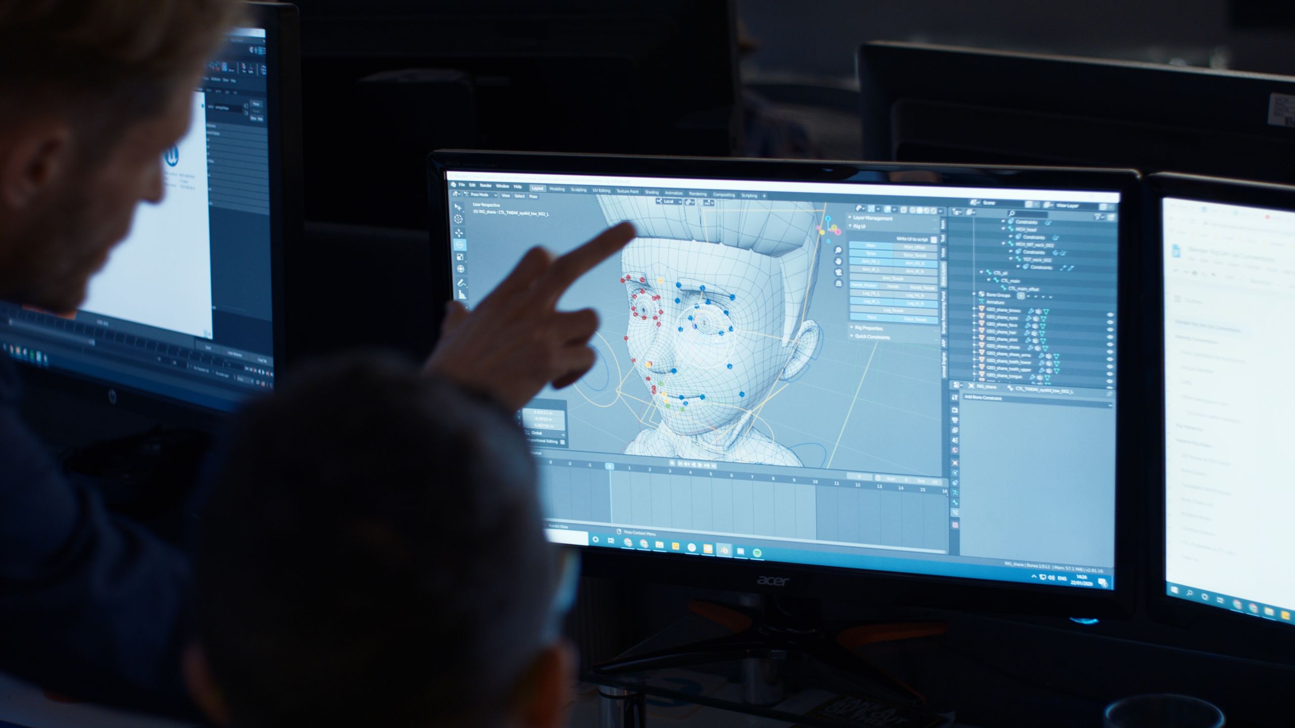 Animators use a computer program to create a cartoon face.